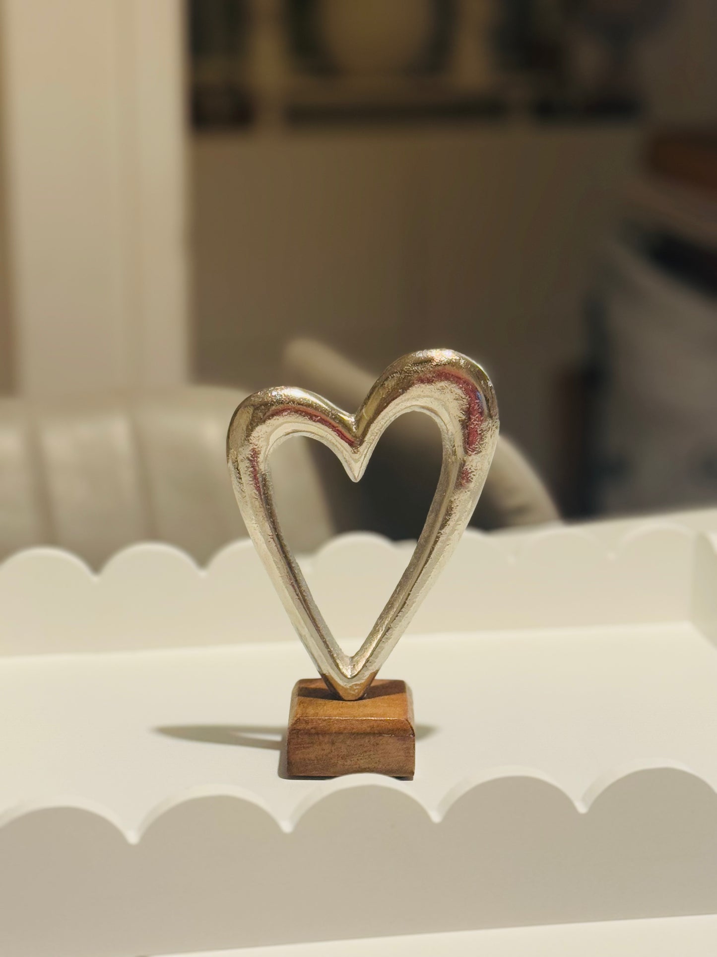 Small metal heart on wooden base