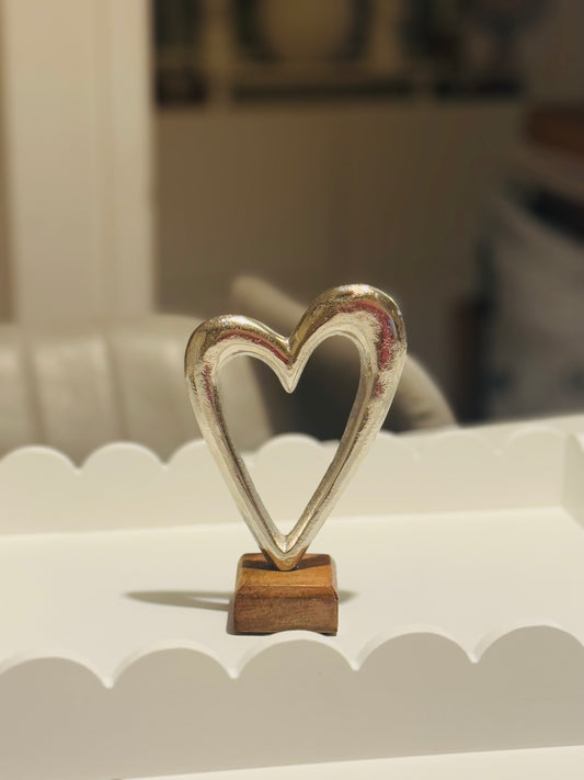 Small metal heart on wooden base